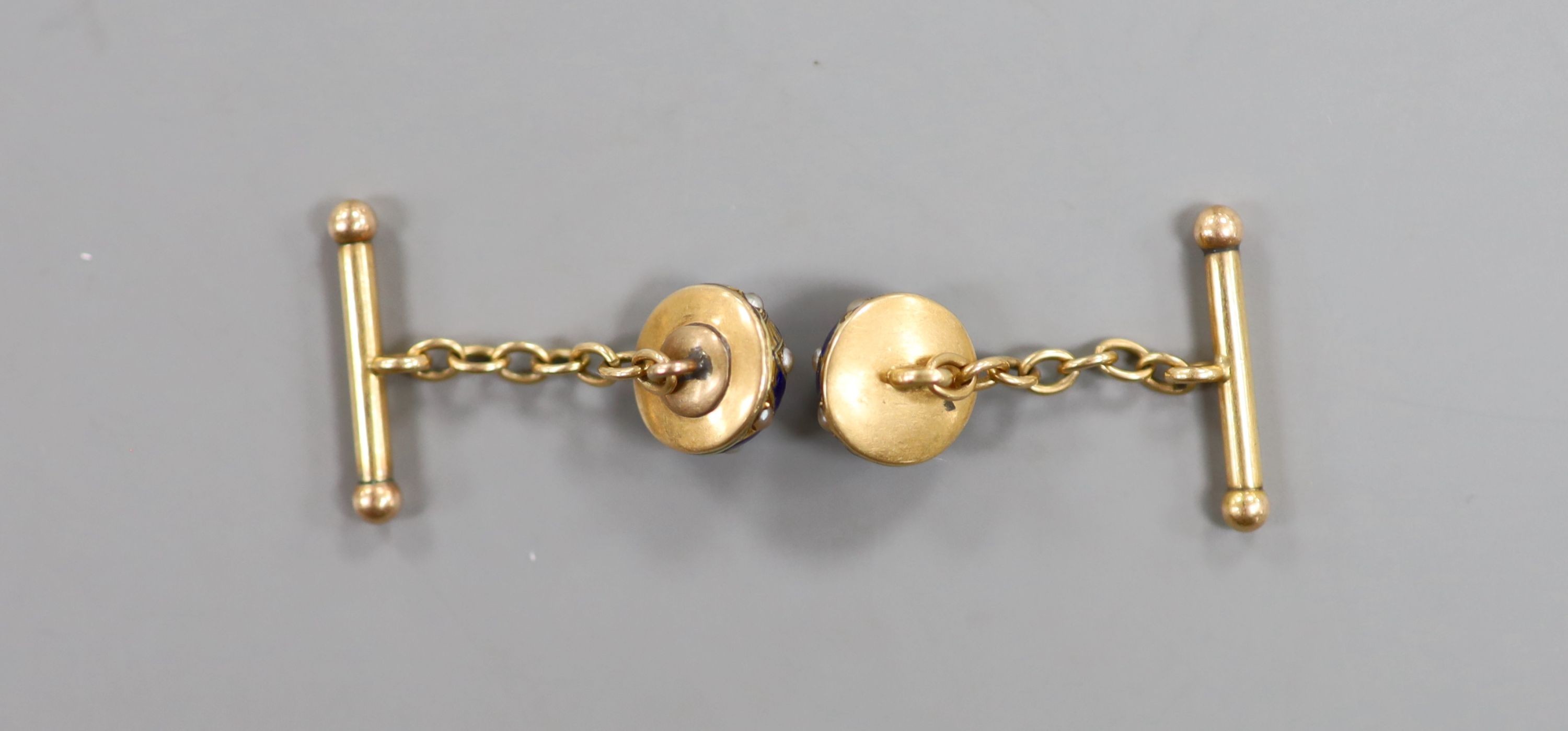 A pair of early 20th century yellow metal, blue enamel and split pearl set domed cufflinks (a.f.), 11mm, gross weight 7.2 grams.